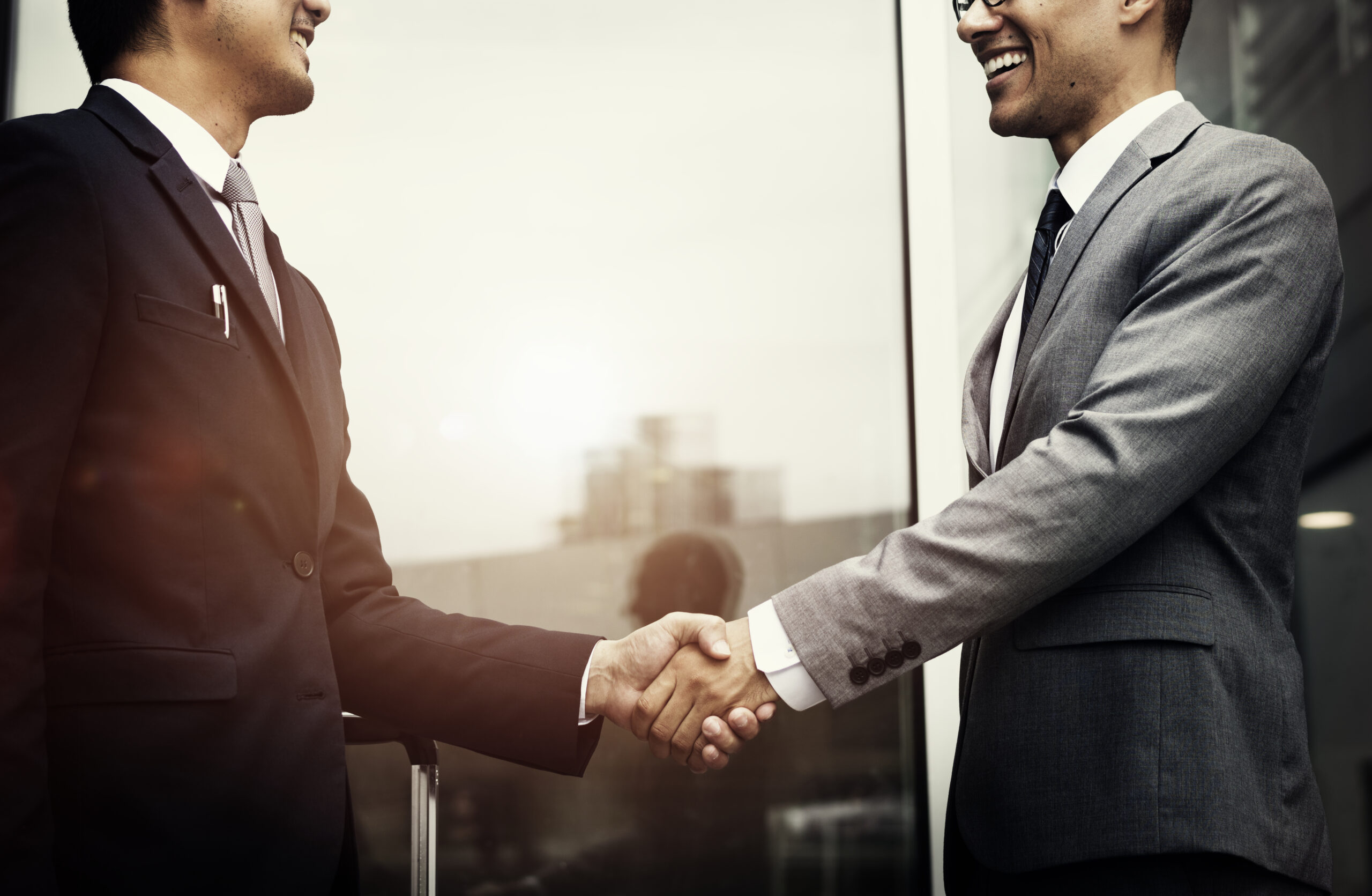 Corporate businessmen shaking hands